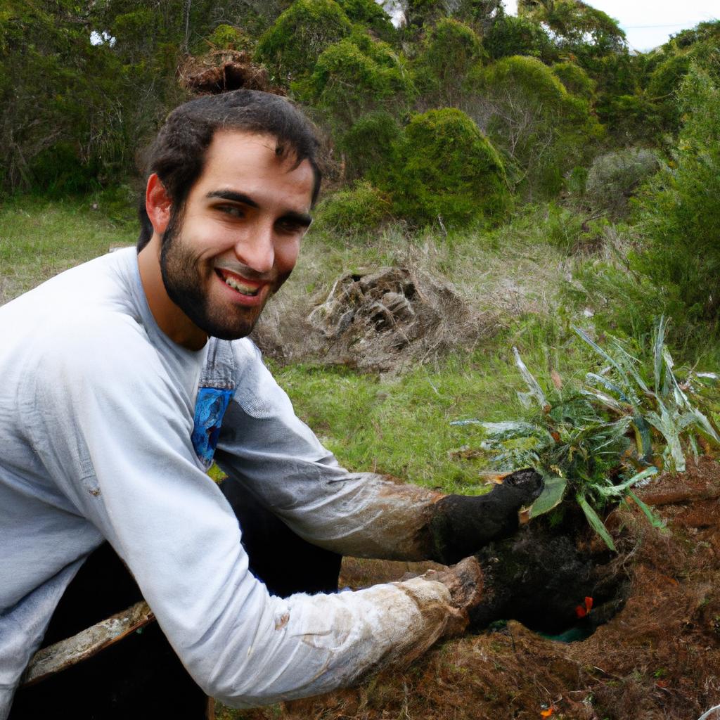 Person planting native plants, smiling